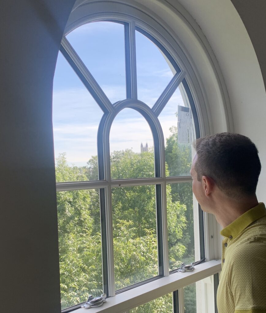 Leader of Canterbury City Council, Ben Fitter-Harding, looking out the window at Canterbury Cathedral in a Kingfisher Close property 