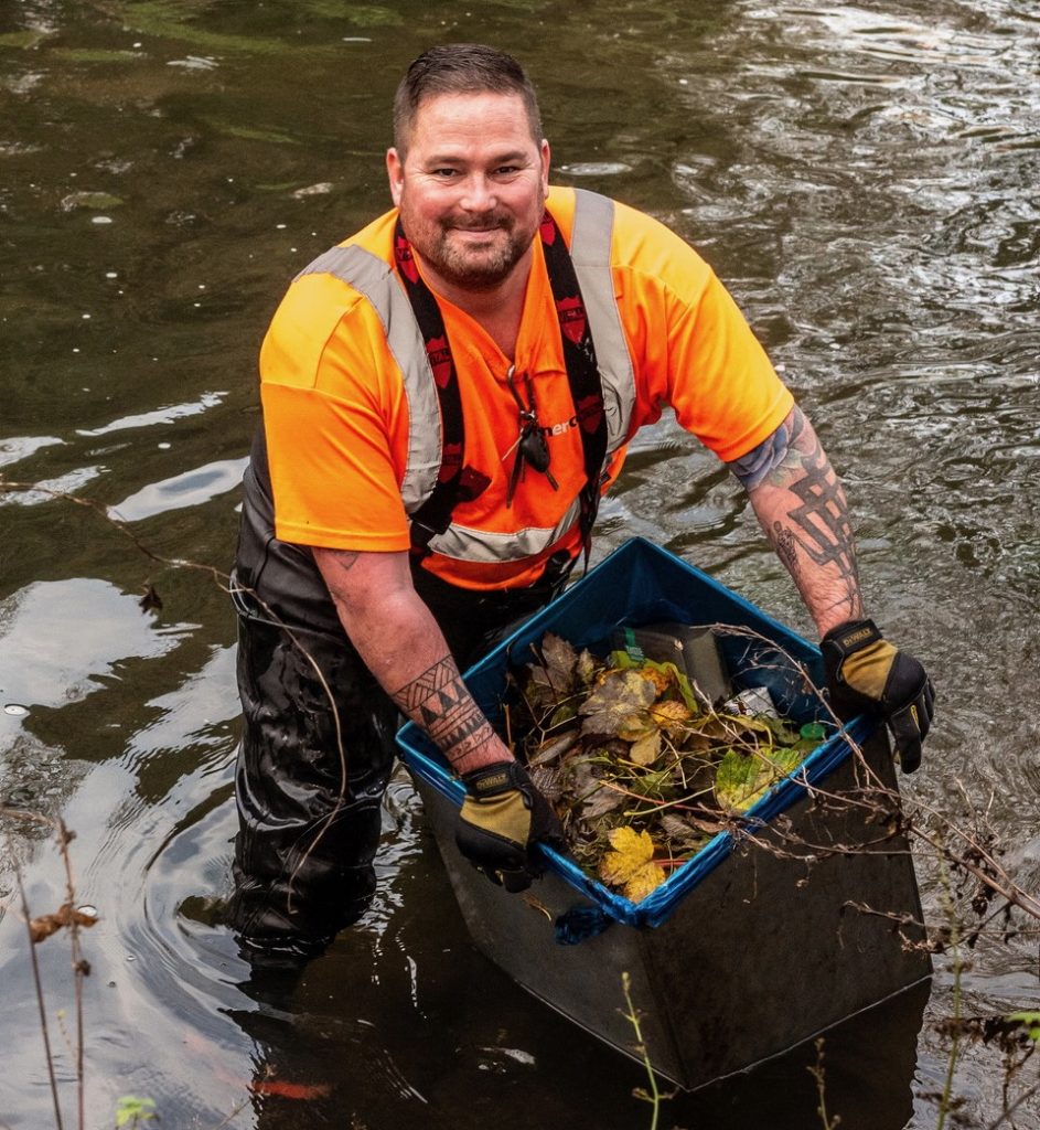 Canenco crew member removing the bins from the river