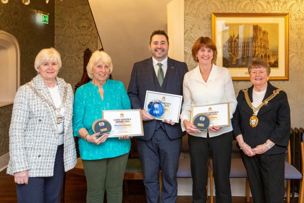 The Lady Mayoress the Lord Mayor standing for a photograph with the award winners holding their certificates