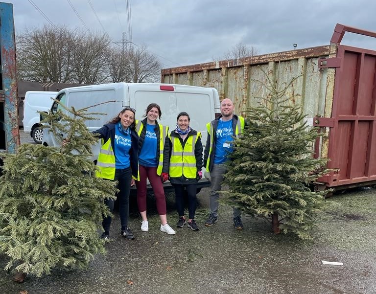 Representatives from Pilgrims Hospice pictured with Christmas trees that have been collected