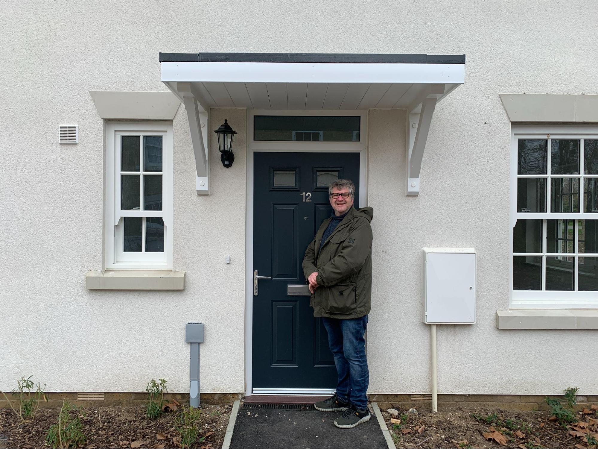 Cllr Joe Howes standing in front of one of the Kingfisher Close social houses