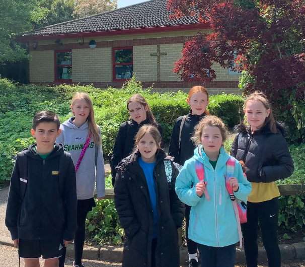 Herne Junior School children standing outside the school