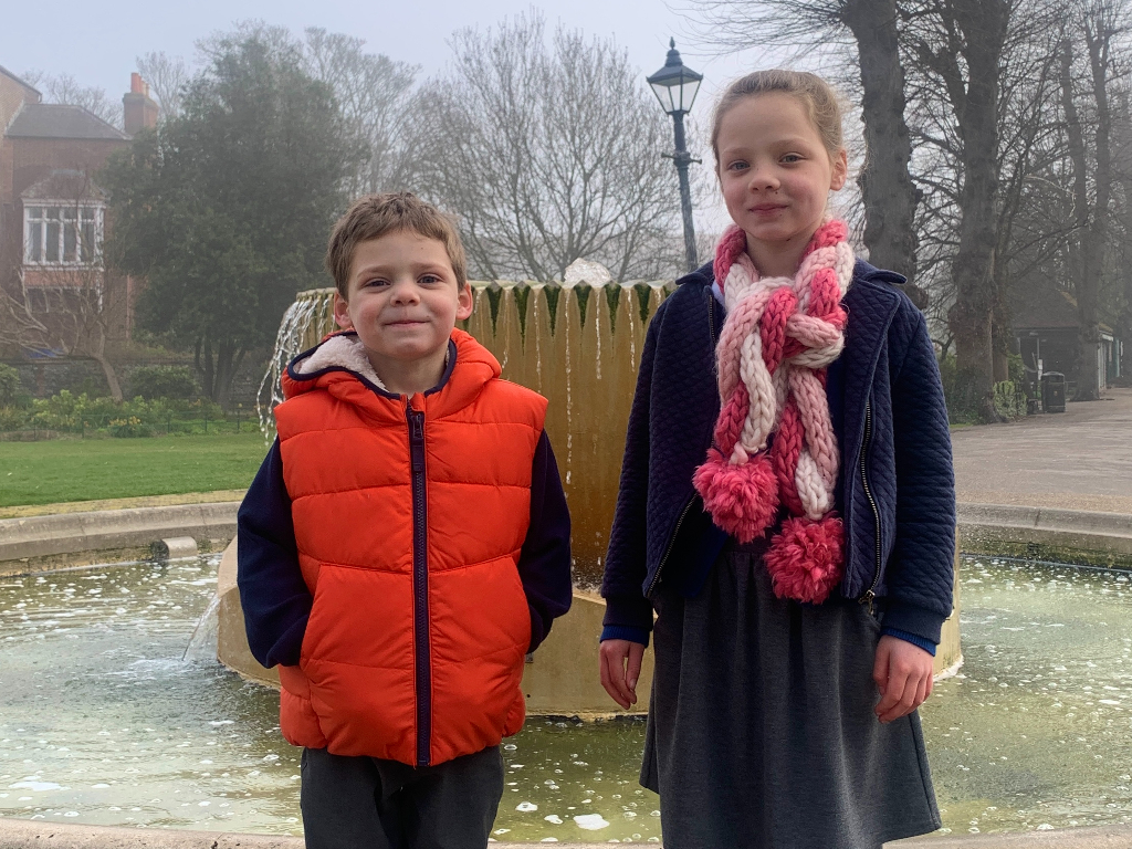 Tom and Emma standing in front of Dane John Garden's water fountain