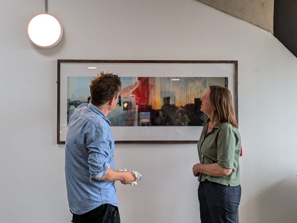 Artist Phil Miller and Cllr Clare Turnbull looking at the artwork on the wall